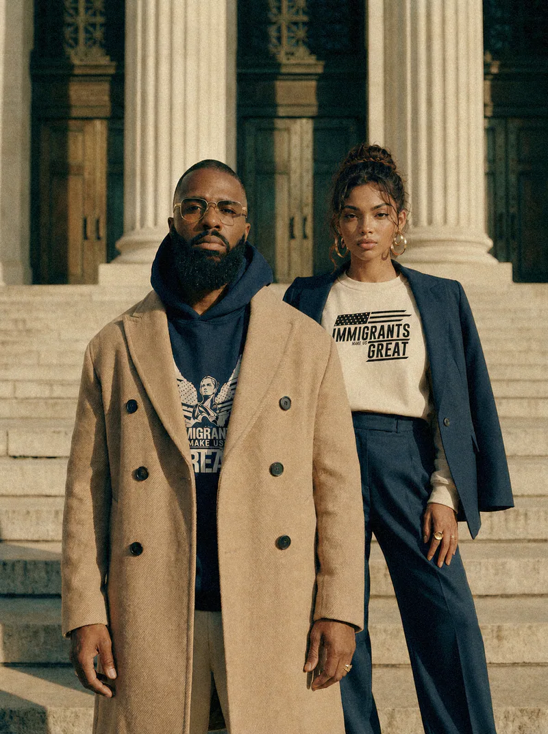 Two wearers on the steps of a civic building, in the Winged Liberty hoodie and crewneck